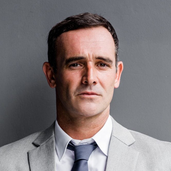 Fees 2 Smart And Successful Businessman In Suit Posing Isolated Over Grey Background E1622289371710
